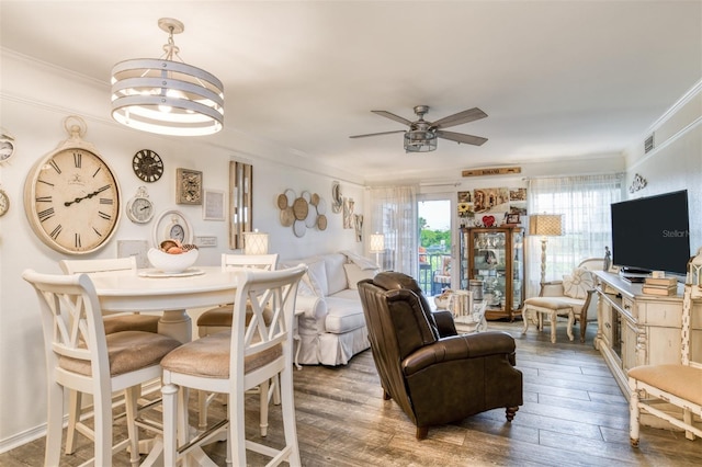 110 Ocean Hollow Ln Unit 101, Saint Augustine, FL 32084 - dining area with ornamental molding, hardwood / wood-style floors, a ceiling fan, and a chandelier