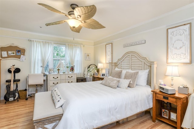 bedroom featuring light wood-type flooring, crown molding, and ceiling fan