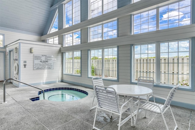 view of swimming pool with an indoor hot tub