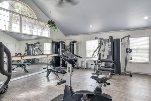 exercise room with high vaulted ceiling, ornamental molding, ceiling fan, and hardwood / wood-style floors