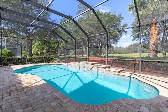 view of swimming pool featuring a patio area and glass enclosure