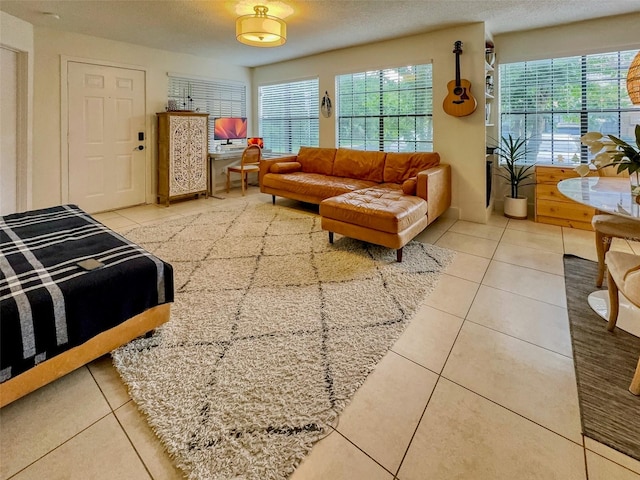 tiled living room featuring a textured ceiling