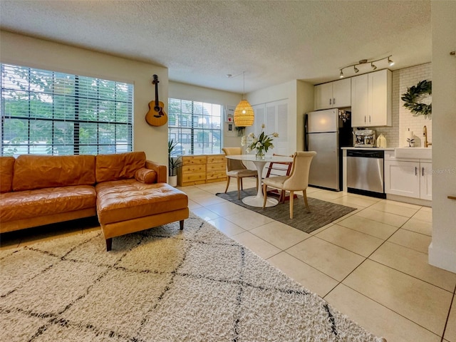 tiled living room featuring a textured ceiling and sink