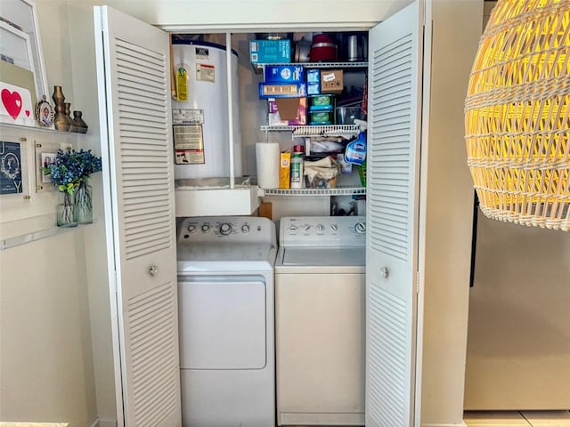 laundry room with gas water heater and independent washer and dryer