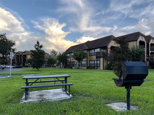 view of home's community with a yard