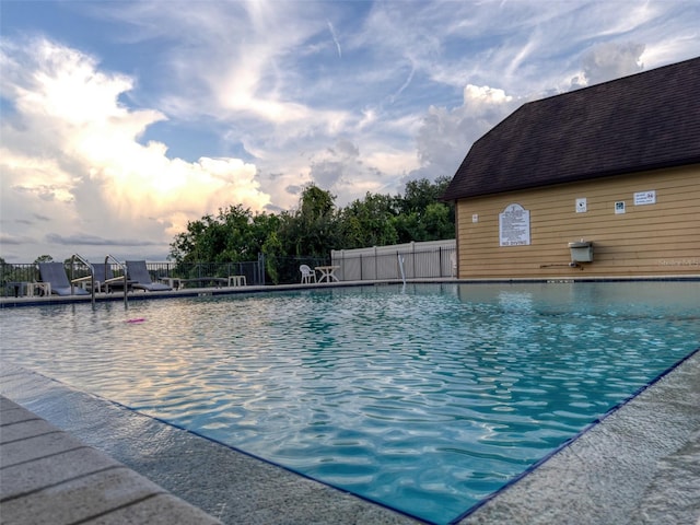 view of pool at dusk