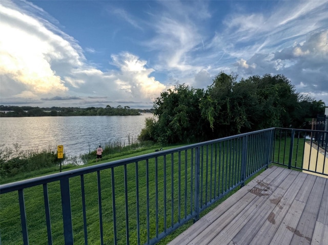 wooden deck featuring a water view and a yard