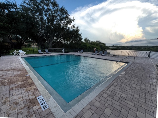 view of swimming pool with a patio area