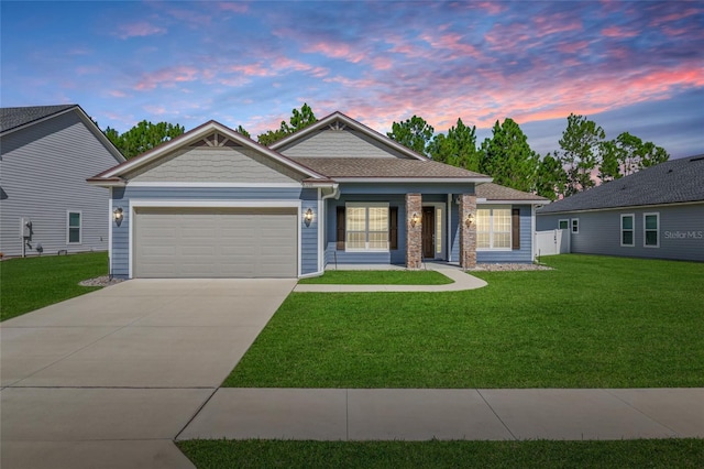 view of front facade with a garage and a lawn