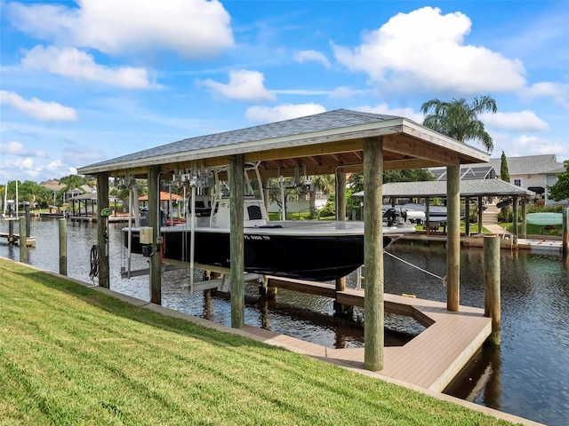 dock area with a water view and a yard