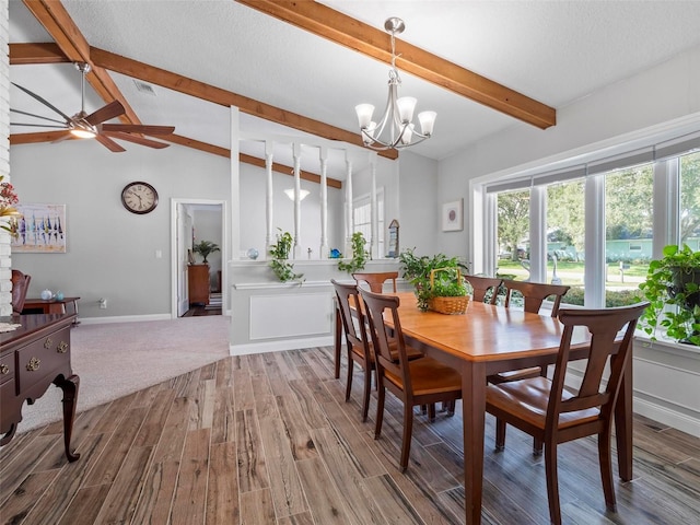 dining room with vaulted ceiling with beams, hardwood / wood-style flooring, ceiling fan with notable chandelier, and a textured ceiling