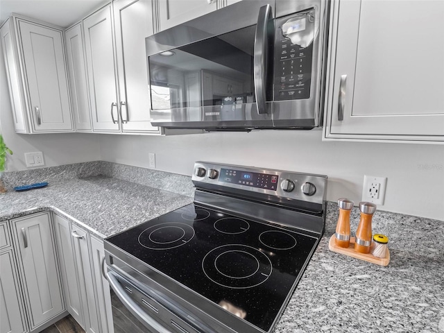 kitchen with stainless steel appliances and light stone counters