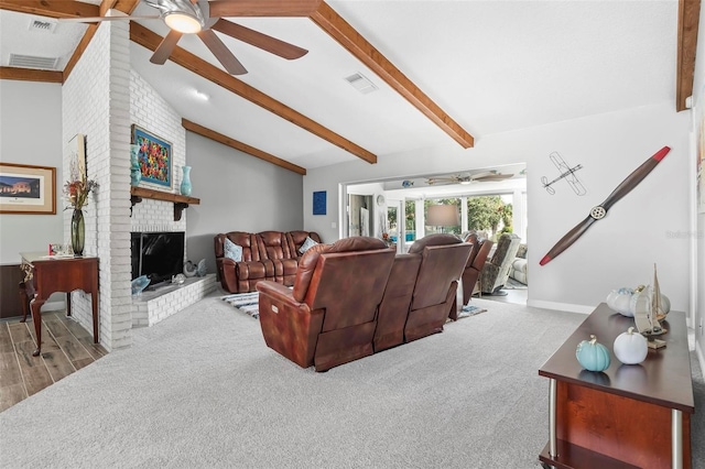 living room with light hardwood / wood-style floors, vaulted ceiling with beams, a fireplace, and ceiling fan