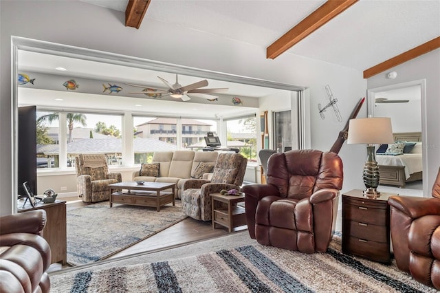 living room featuring ceiling fan, lofted ceiling with beams, hardwood / wood-style floors, and a healthy amount of sunlight