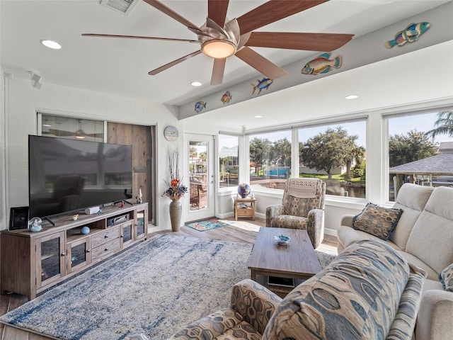 living room with ceiling fan and hardwood / wood-style flooring