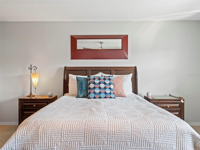 bedroom featuring a textured ceiling and carpet flooring