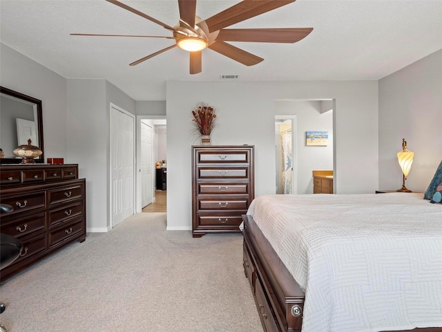 carpeted bedroom featuring connected bathroom and ceiling fan