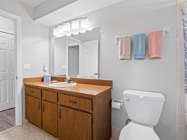 bathroom featuring curtained shower, wood-type flooring, vanity, and toilet