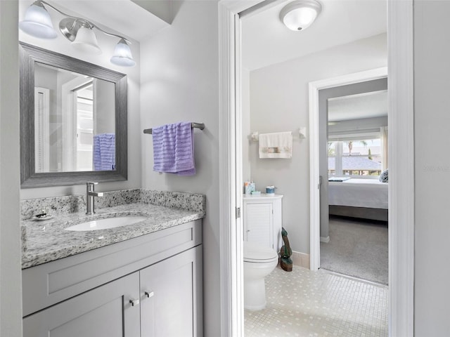 bathroom featuring tile patterned floors, vanity, and toilet