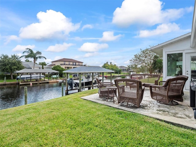 dock area with a lawn and a water view