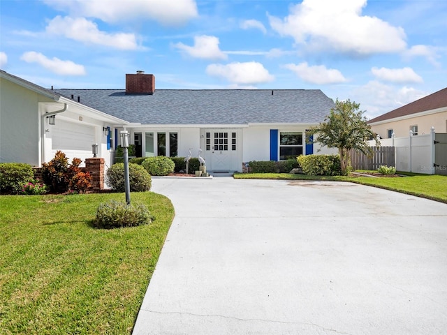 ranch-style home with a front yard and a garage