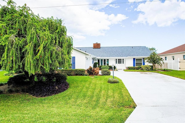 ranch-style home with a front lawn