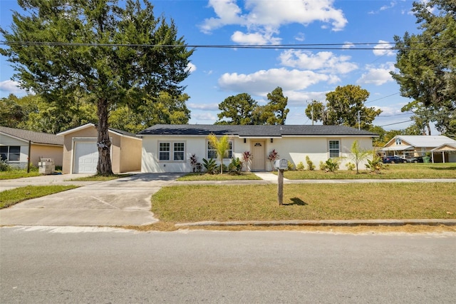 single story home with a front yard and a garage