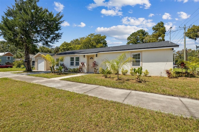 single story home with a front yard and a garage