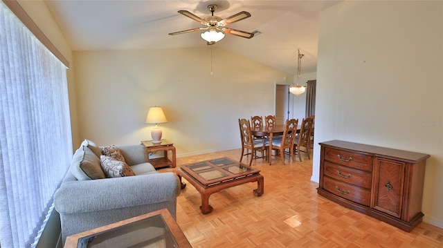 living room featuring ceiling fan, lofted ceiling, and light parquet flooring