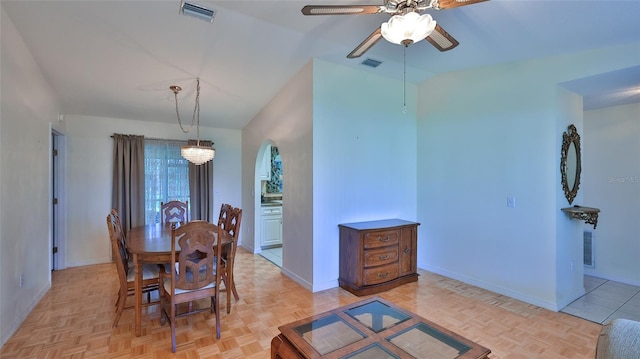 dining space featuring ceiling fan with notable chandelier and light parquet floors