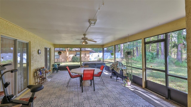 sunroom / solarium featuring ceiling fan and a healthy amount of sunlight