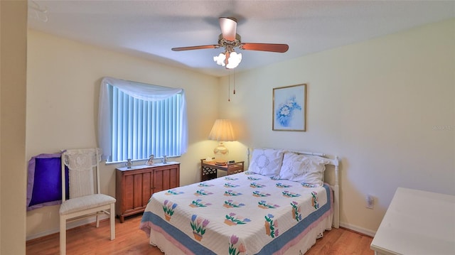 bedroom featuring light hardwood / wood-style floors and ceiling fan