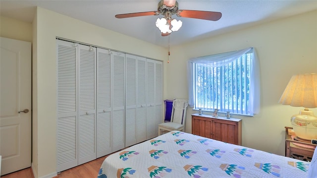 bedroom featuring ceiling fan, a closet, and light hardwood / wood-style floors