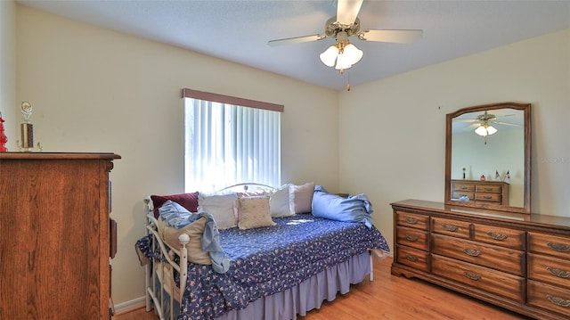 bedroom featuring light wood-type flooring and ceiling fan