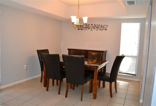 dining area featuring a chandelier and light tile patterned floors