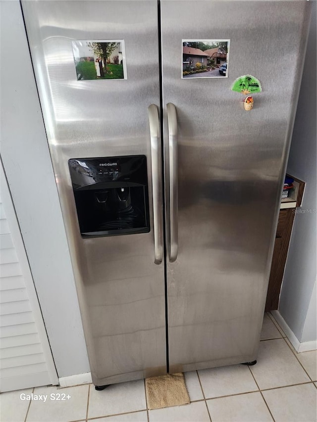 details featuring stainless steel fridge with ice dispenser