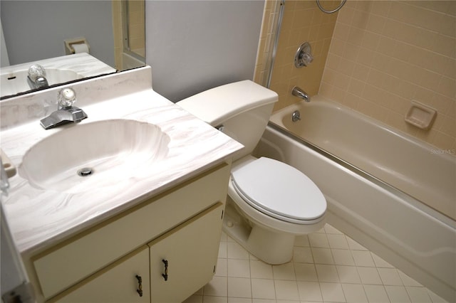 full bathroom featuring tiled shower / bath, tile patterned flooring, vanity, and toilet