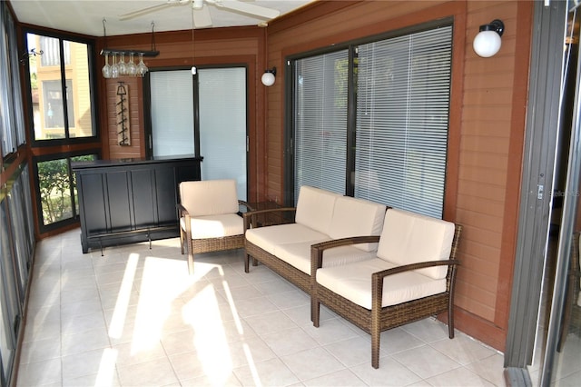 sunroom featuring ceiling fan