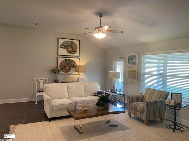 living room featuring lofted ceiling, hardwood / wood-style floors, and ceiling fan