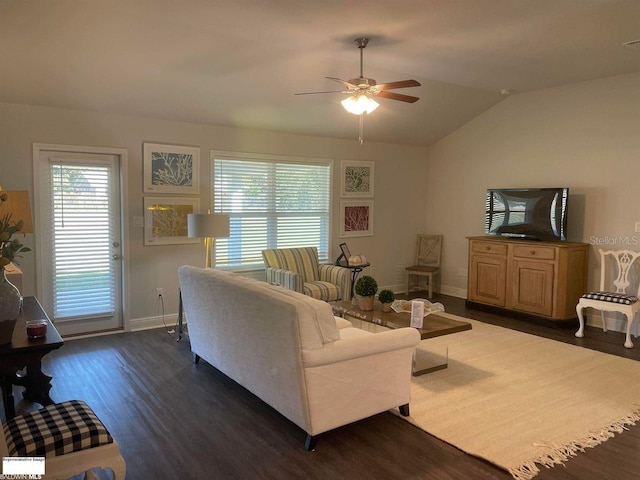 living room featuring vaulted ceiling, dark wood-type flooring, and ceiling fan