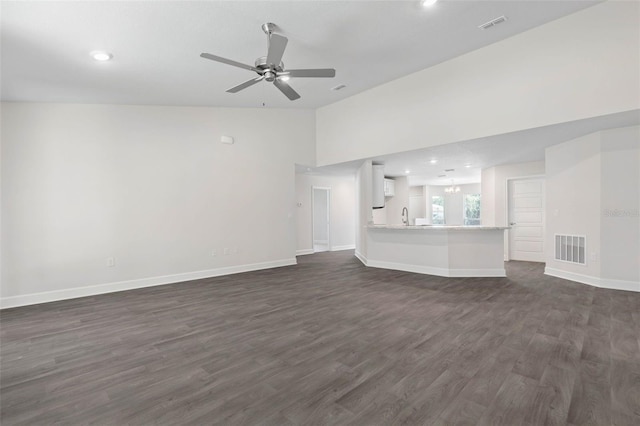 unfurnished living room featuring lofted ceiling, sink, dark hardwood / wood-style flooring, and ceiling fan