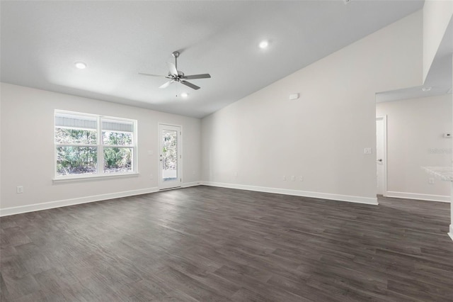 empty room with ceiling fan, dark hardwood / wood-style flooring, and high vaulted ceiling