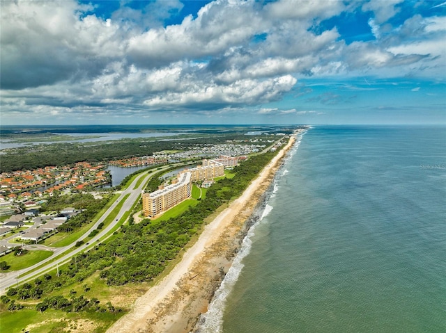 birds eye view of property featuring a water view and a beach view