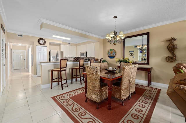 tiled dining area featuring ornamental molding and a chandelier