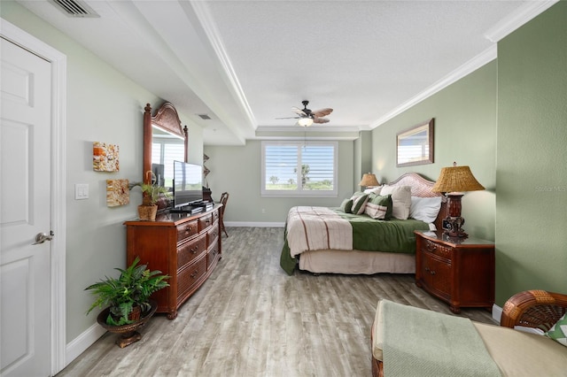 bedroom featuring light hardwood / wood-style flooring, ceiling fan, and crown molding