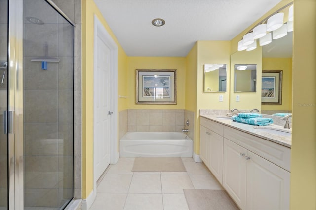 bathroom featuring vanity, plus walk in shower, a textured ceiling, and tile patterned floors