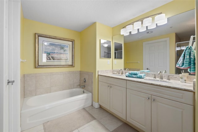 bathroom with a bathtub, tile patterned flooring, and vanity