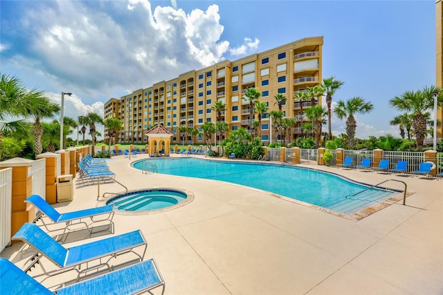 view of pool featuring a patio and a community hot tub