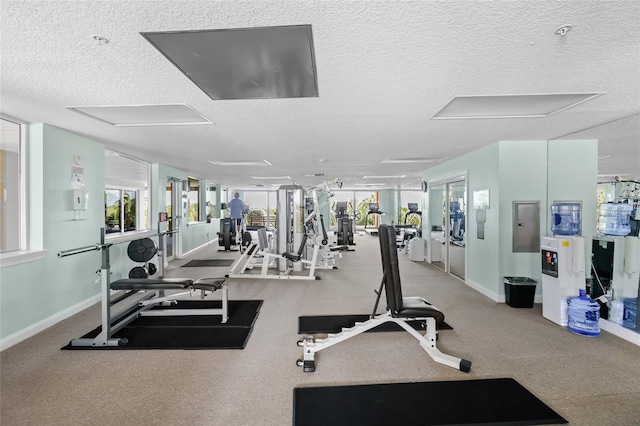 exercise room with a textured ceiling