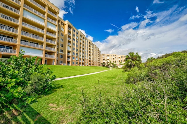 view of home's community featuring a lawn